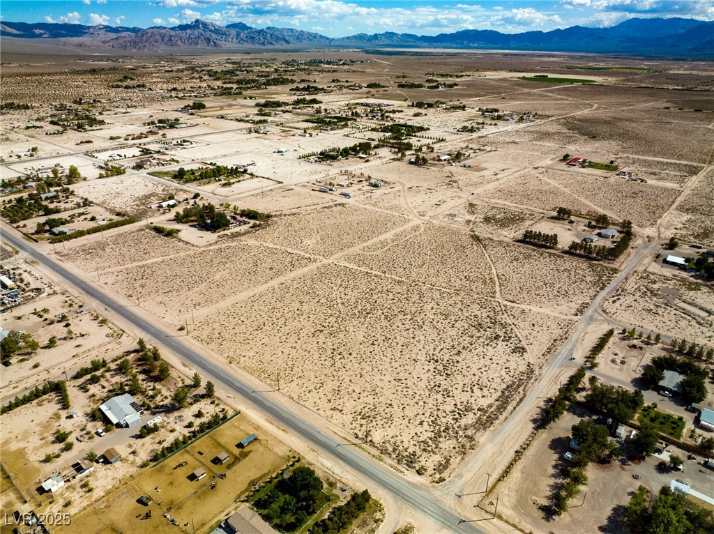 Marble Sandy Valley, NV 89019 - Photo 13 of 31 Birds eye view of property with a rural view, a mountain view, and view of desert