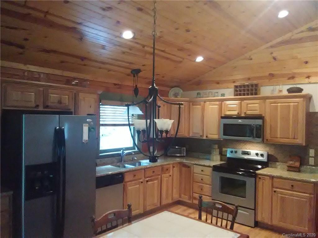 308 Cinnamon Ridge Rutherfordton, NC 28139 - Photo 13 of 19 a kitchen with granite countertop a stove and a refrigerator