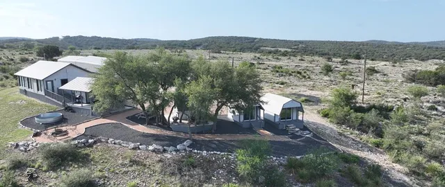 a view of a house with wooden floor roof and wooden fence