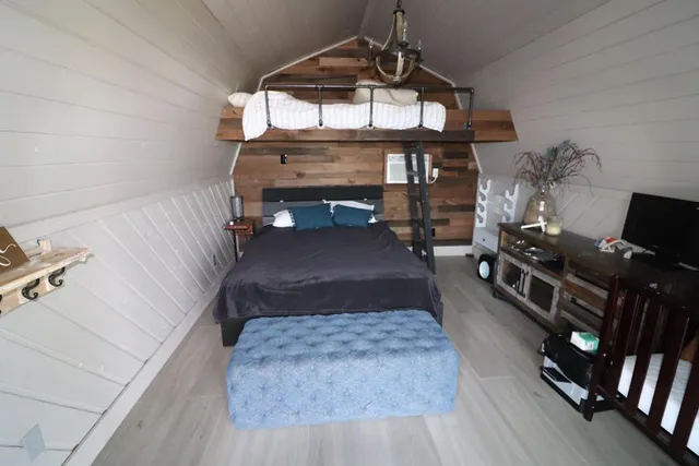 an aerial view of residential houses with outdoor space and trees