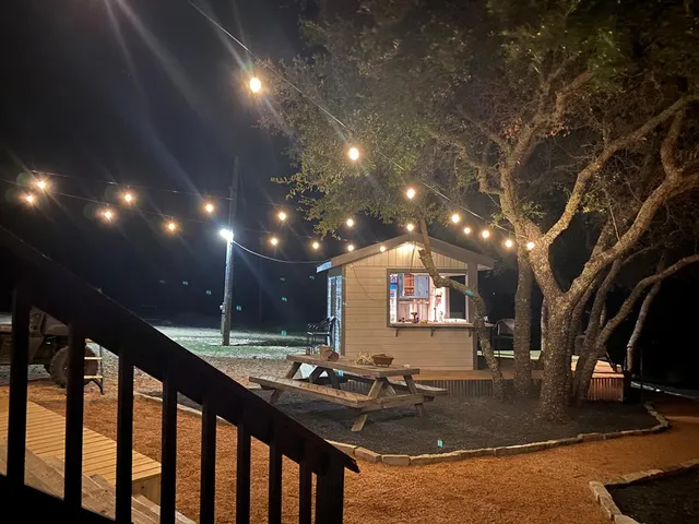 an aerial view of residential houses with outdoor space and trees
