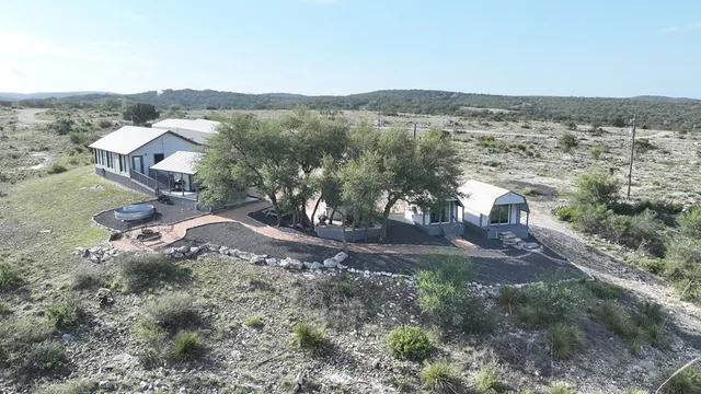 a view of a patio with table and chairs and potted plants with wooden floor and fence