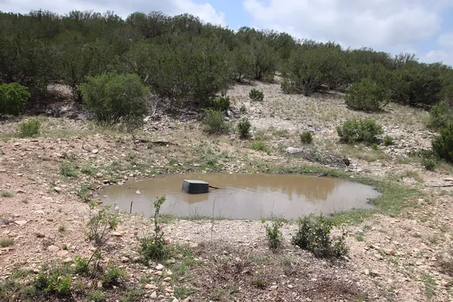 a bedroom with a bed and a flat tv screen