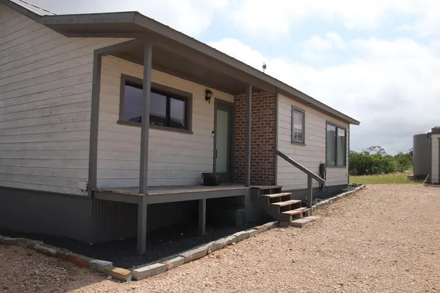 a view of a livingroom with workspace and a window