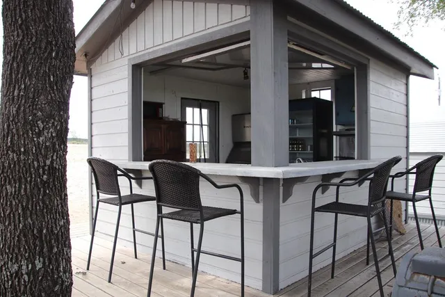 a view of a table and chairs under an umbrella