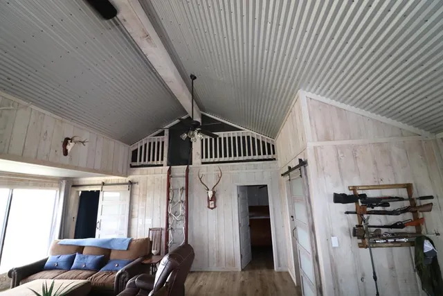 a view of a dry yard with trees and shower in a room