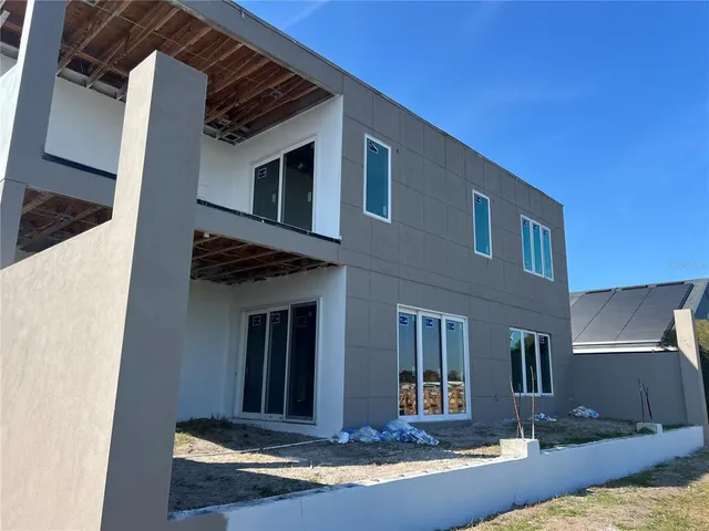a large kitchen with stainless steel appliances kitchen island a large counter top and wooden floors