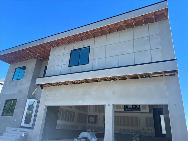 a bathroom with a white tub a sink and mirror