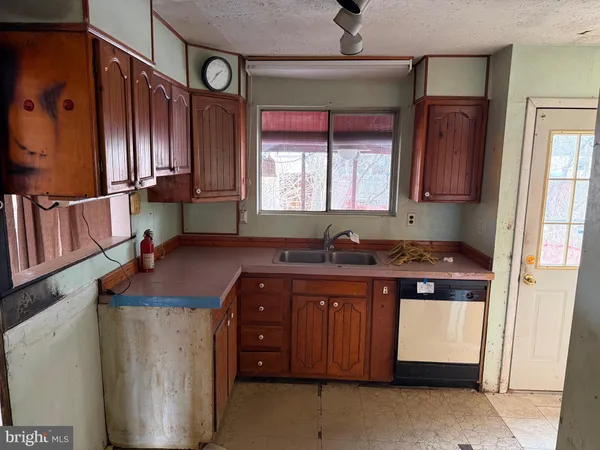a kitchen with stainless steel appliances granite countertop a sink and a stove