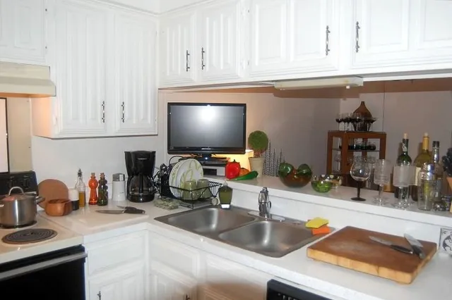 a kitchen with a sink and a stove top oven