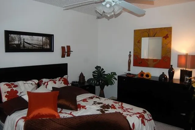 a bedroom with bed and a chandelier