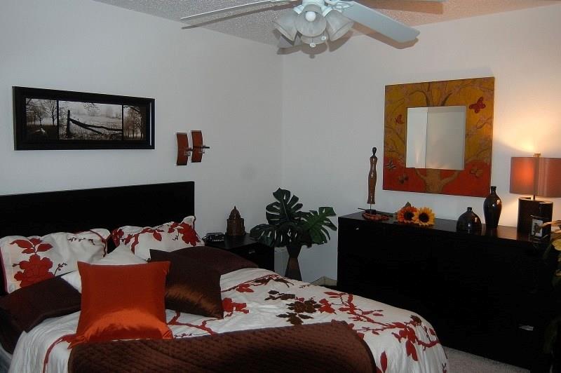 5630 Spring Valley Road, Unit 23A Dallas, TX 75254 - Photo 15 of 18 a bedroom with bed and a chandelier