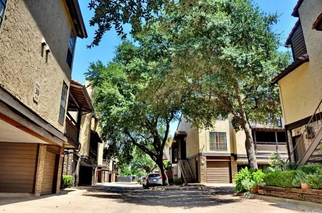 a front view of a house with a tree