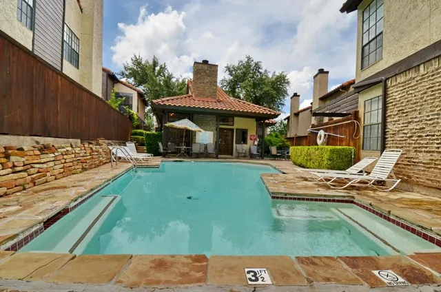 a view of a swimming pool with a yard