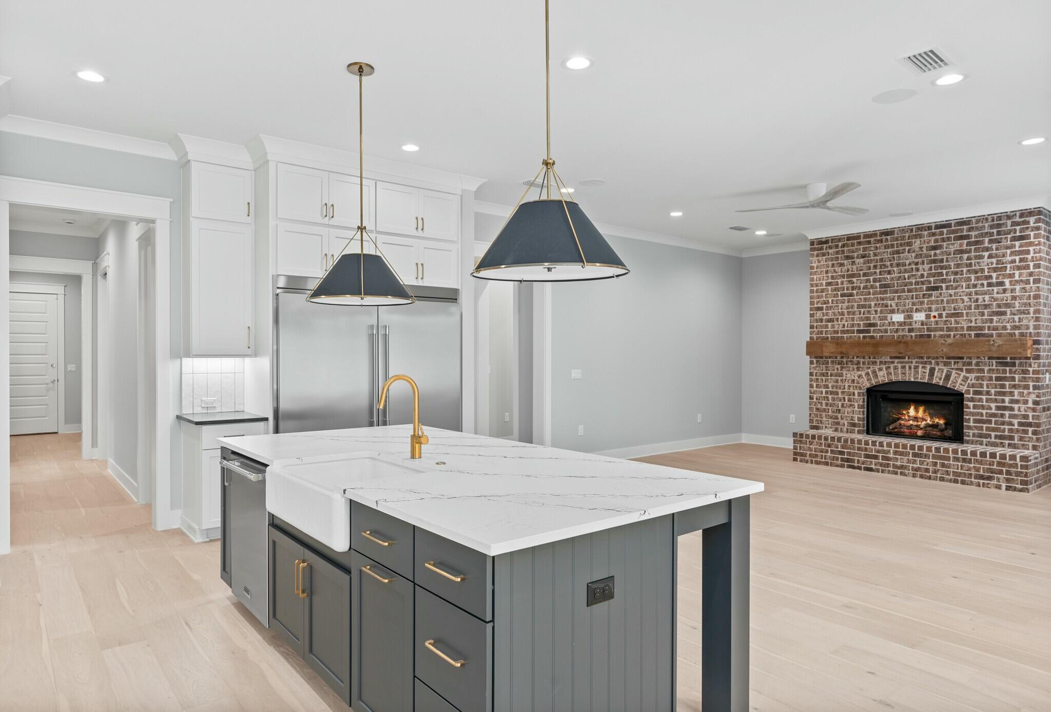 73 Sparkle Street Freeport, FL 32439 - Photo 16 of 27 a kitchen with a stove a refrigerator a sink and a fireplace