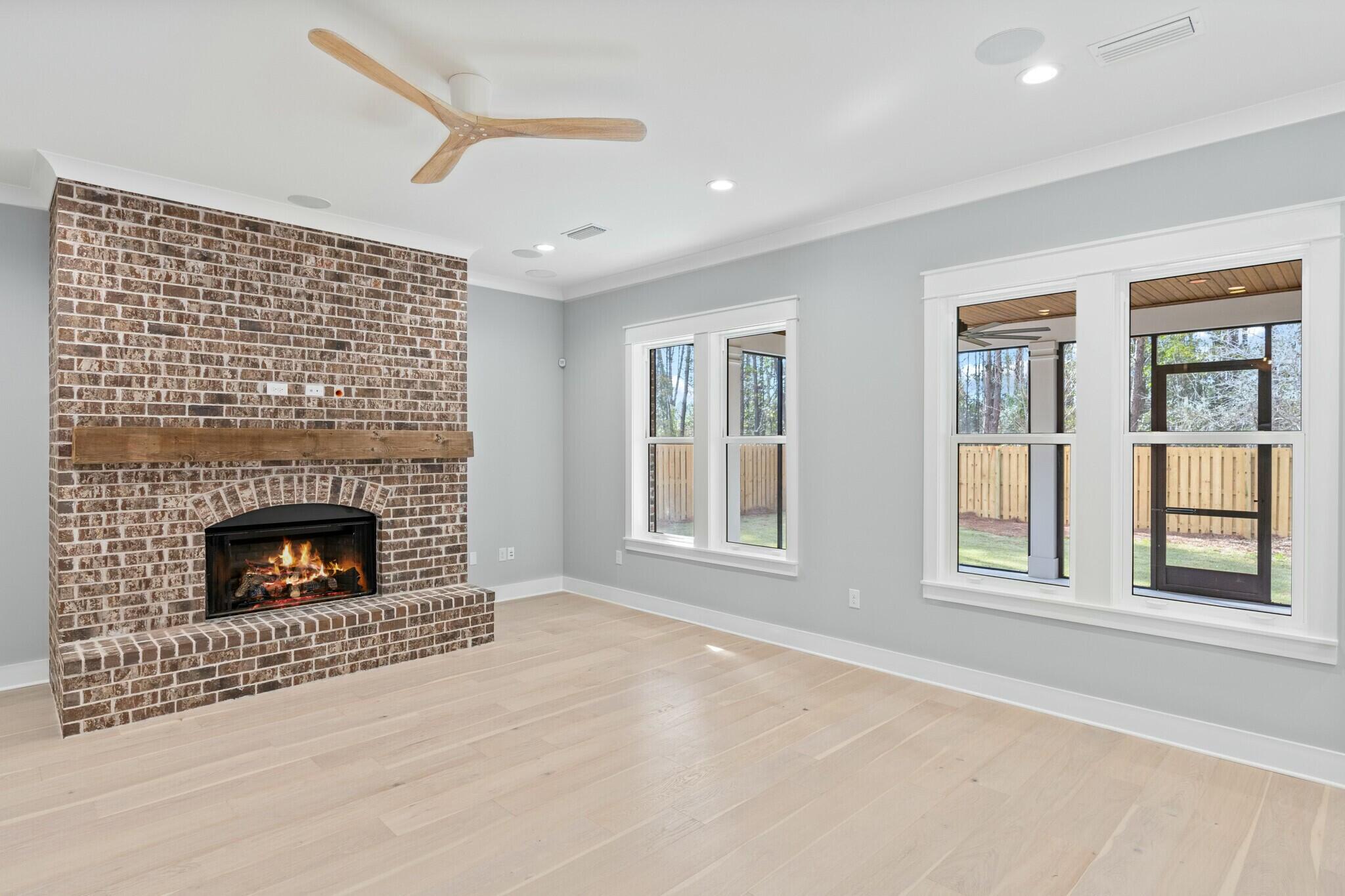 73 Sparkle Street Freeport, FL 32439 - Photo 4 of 27 a living room with a fireplace and windows