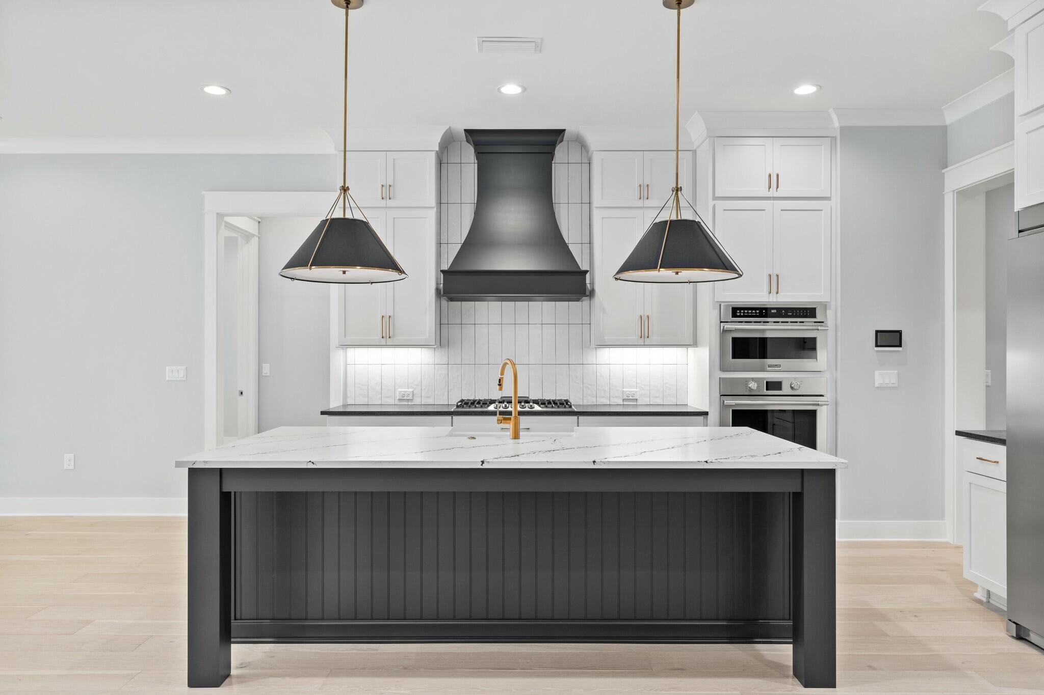 73 Sparkle Street Freeport, FL 32439 - Photo 6 of 27 a kitchen with stainless steel appliances granite countertop a sink a stove and a refrigerator