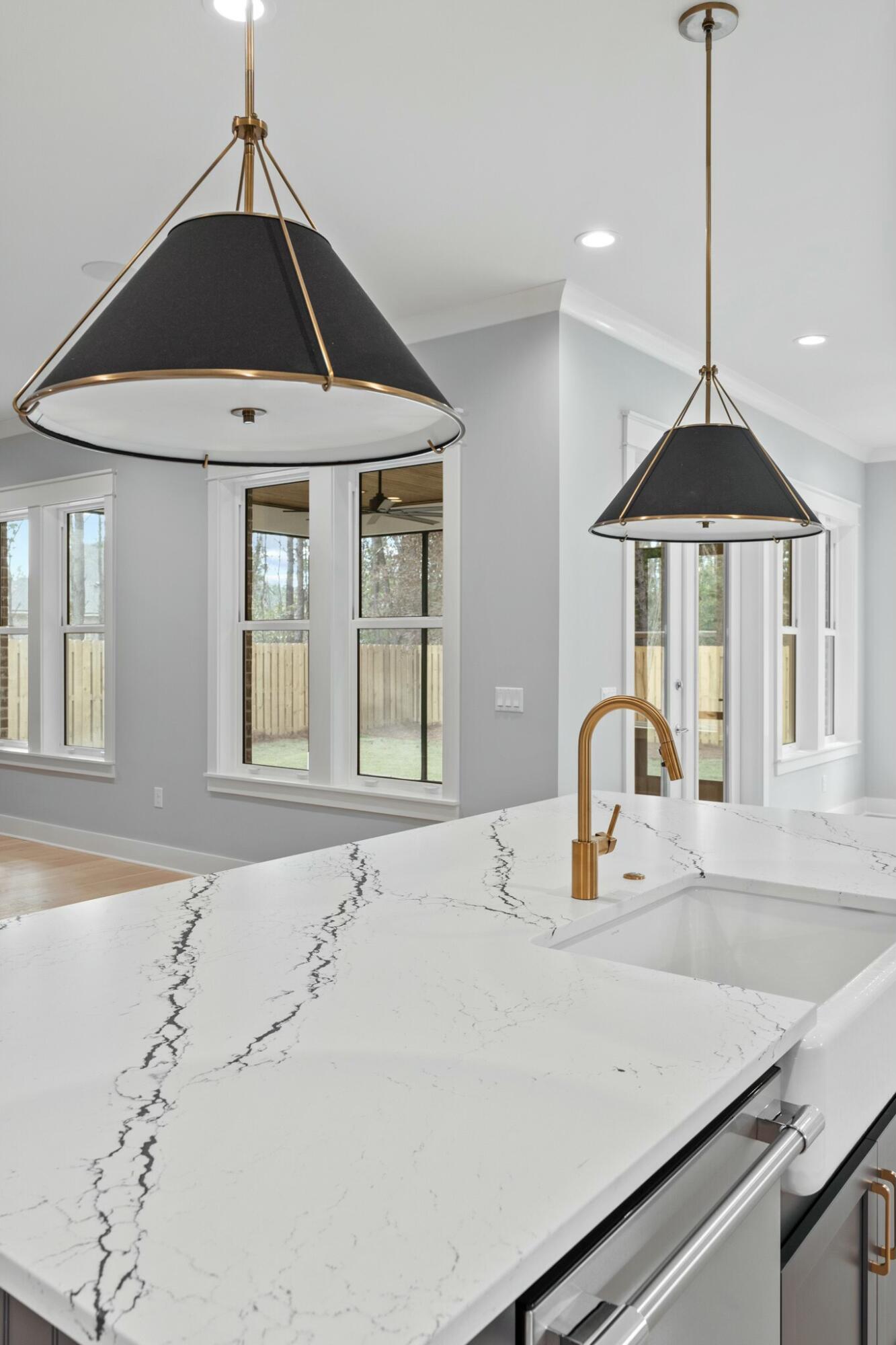 73 Sparkle Street Freeport, FL 32439 - Photo 8 of 27 a kitchen with a sink a stove and a table