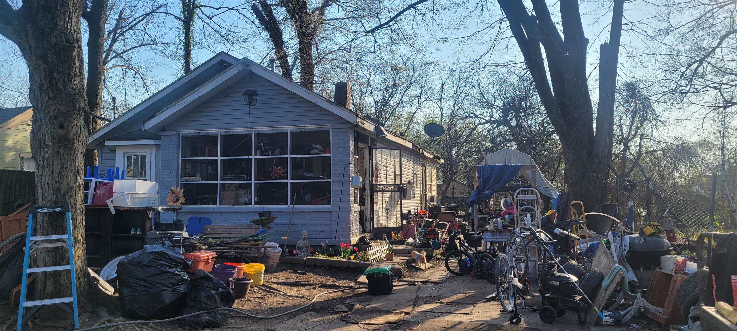a view of a house with yard and sitting area