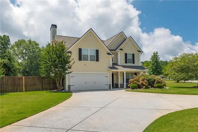 a front view of house with yard and green space