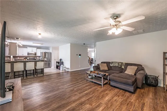 a living room with furniture and wooden floor