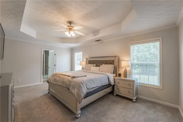 a bedroom with a bed and a ceiling fan in it