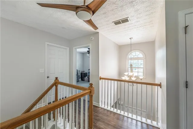 a view of a hallway with windows and stairs