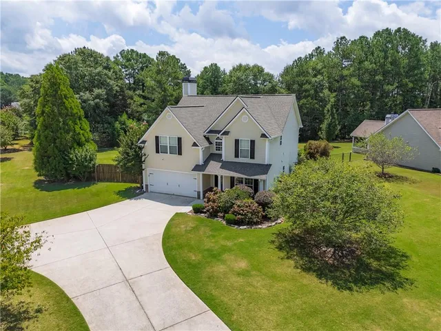 a aerial view of a house with a yard and potted plants