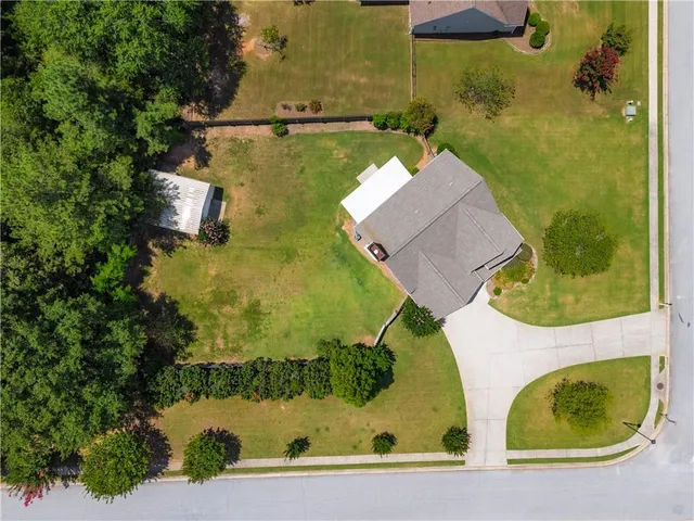 an aerial view of a house with outdoor space swimming pool