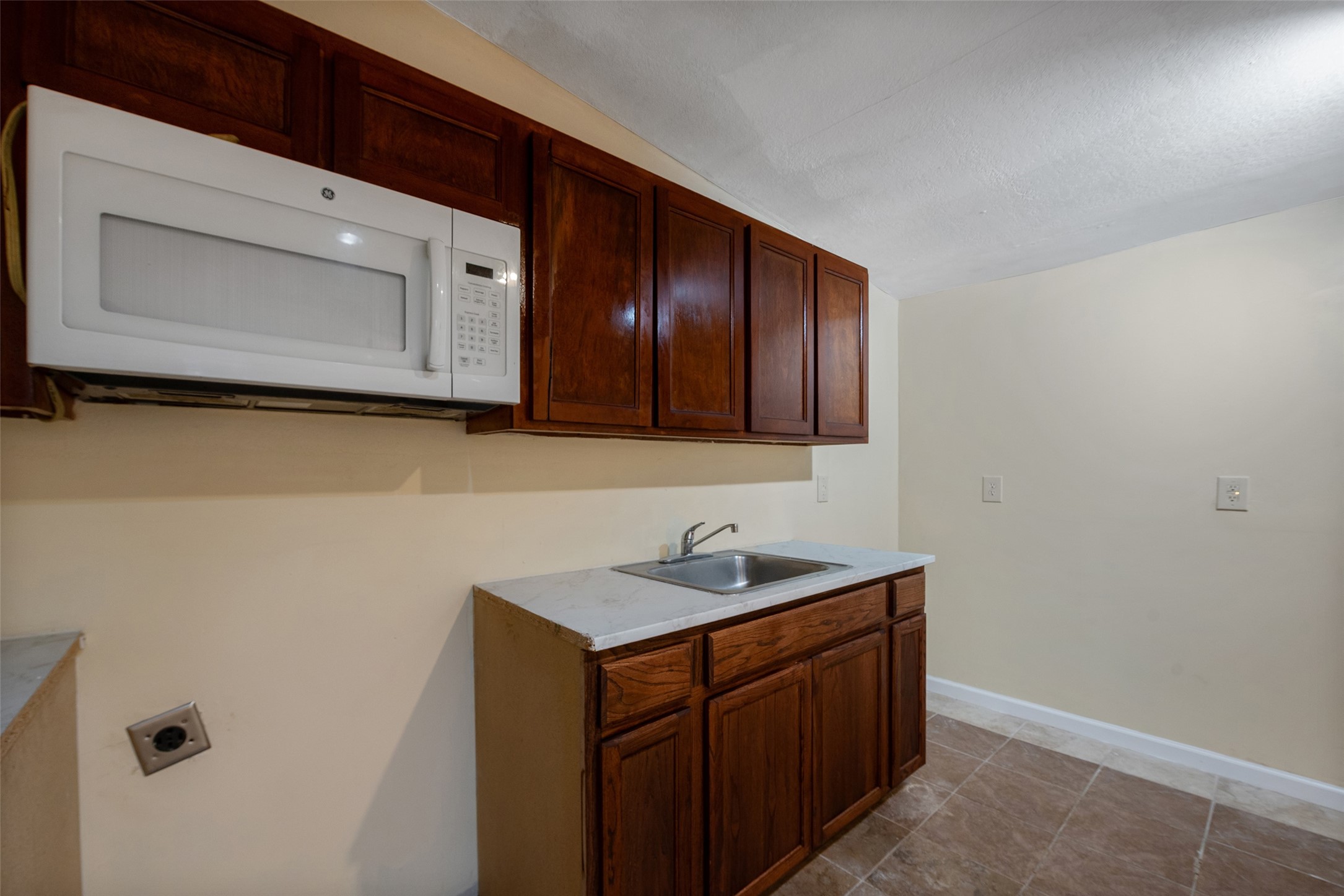 1614 Ryon Street, Unit B Houston, TX 77009 - Photo 13 of 17 a bathroom with a sink a mirror and cabinets