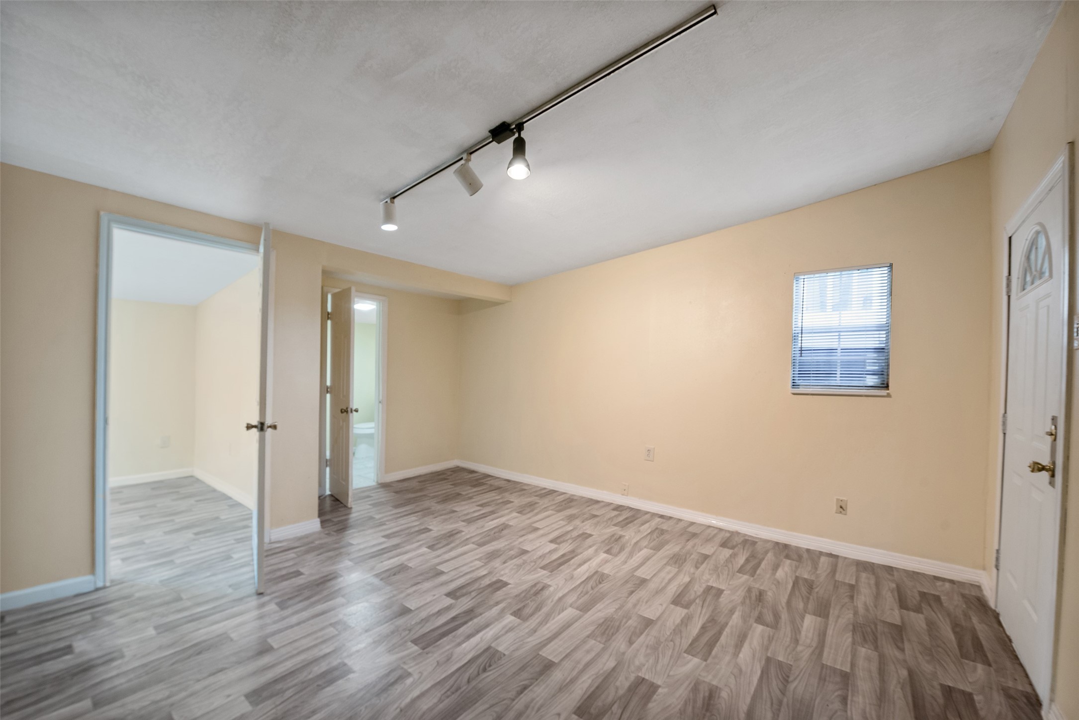 1614 Ryon Street, Unit B Houston, TX 77009 - Photo 6 of 17 an empty room with wooden floor and windows