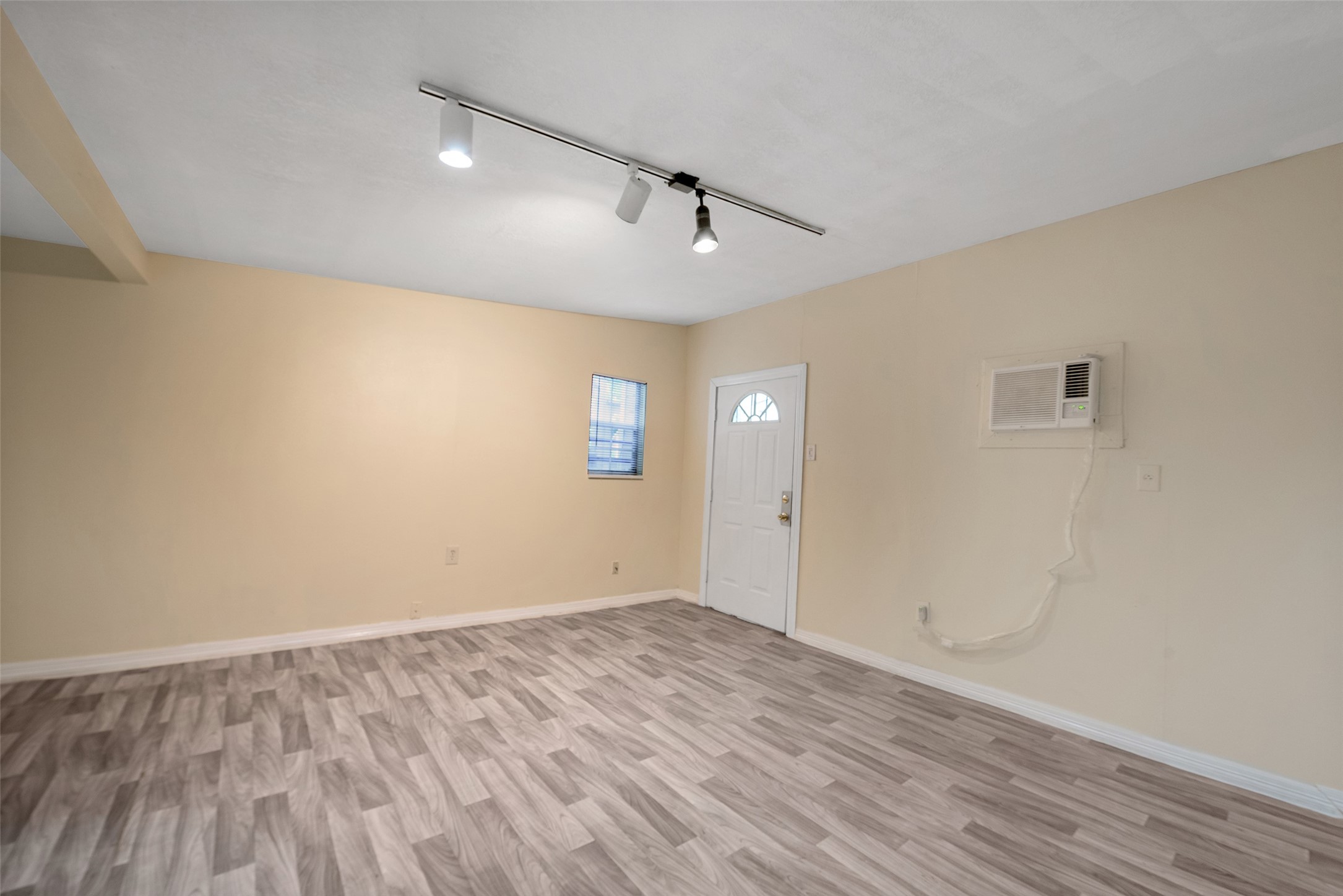 1614 Ryon Street, Unit B Houston, TX 77009 - Photo 7 of 17 an empty room with wooden floor and windows