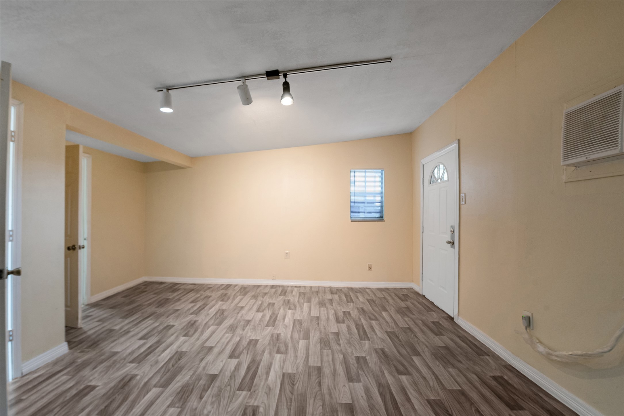 1614 Ryon Street, Unit B Houston, TX 77009 - Photo 9 of 17 an empty room with wooden floor and windows