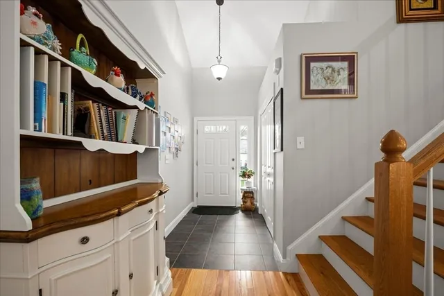 a view of a hallway with wooden floor and staircase
