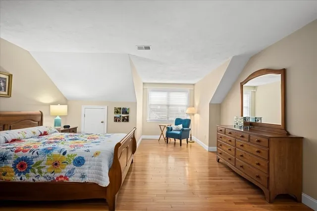 a bedroom with furniture and wooden floor