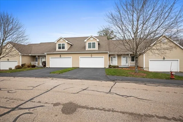 a front view of a house with a yard and a garage