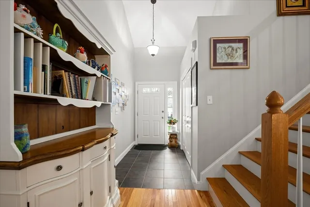 a view of a hallway with wooden floor and staircase