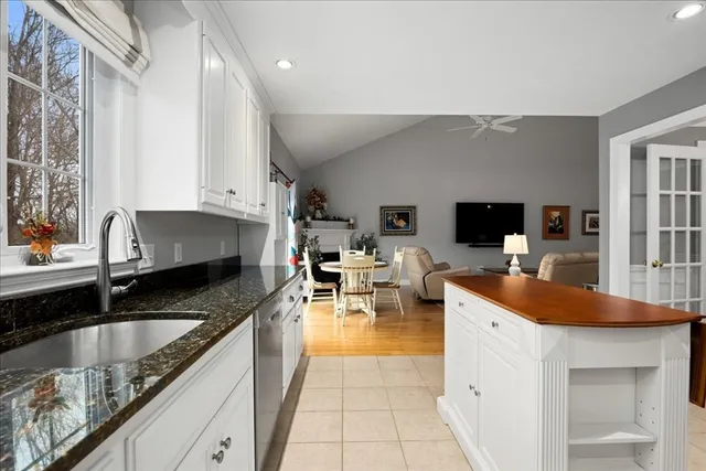 a kitchen with stainless steel appliances granite countertop a sink a stove counter space and cabinets