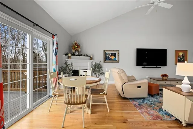a living room with furniture a flat screen tv and a floor to ceiling window