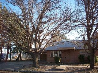 900 10th Street Ralls, TX 79357 - Photo 1 of 1 a large tree in front of a white house