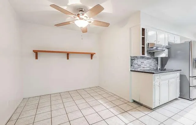 a view of kitchen with cabinets