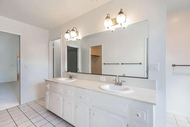 a bathroom with a double vanity sink and a mirror