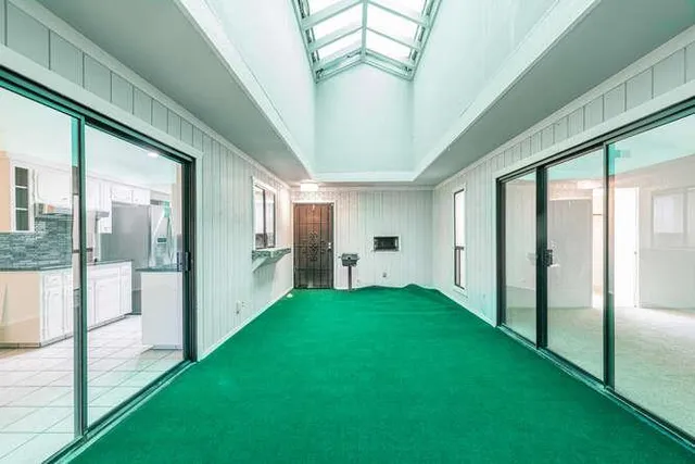 a bathroom with a window sink and mirror