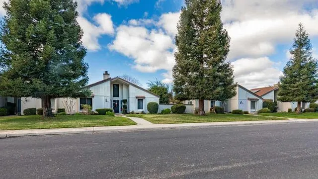 a view of a park with iron fence