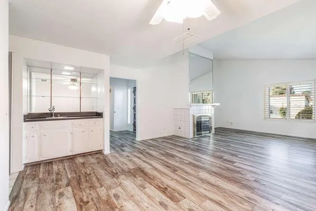 a view of a kitchen with kitchen island wooden floor and window