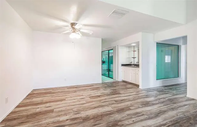 a view of an empty room with a kitchen