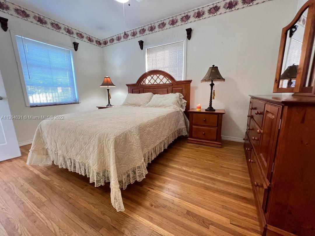 231 West 43rd Street Hialeah, FL 33012 - Photo 11 of 14 a large bed sitting in a room next to a window