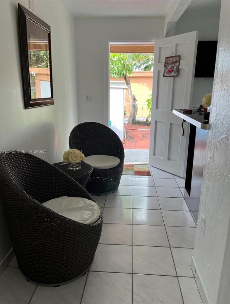231 West 43rd Street Hialeah, FL 33012 - Photo 12 of 14 a living room with a couch and a floor to ceiling window
