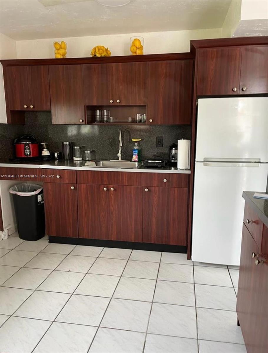 231 West 43rd Street Hialeah, FL 33012 - Photo 13 of 14 a kitchen with stainless steel appliances a refrigerator and a counter
