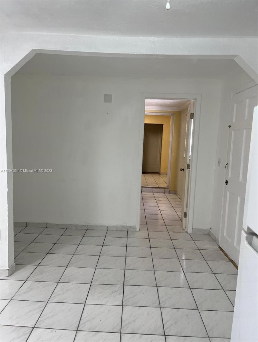 231 West 43rd Street Hialeah, FL 33012 - Photo 14 of 14 a view of a livingroom with an empty space and a window